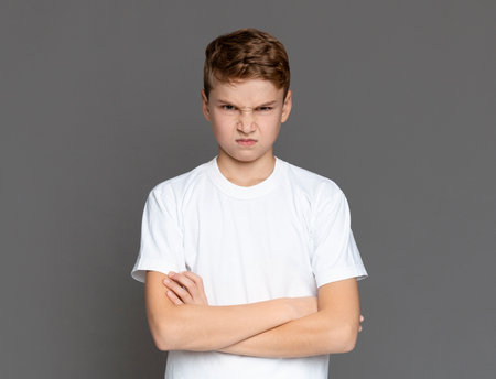 Angry teenager looking at camera with offenceの写真素材