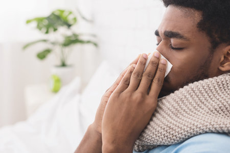 African-american man man has runny nose at homeの写真素材