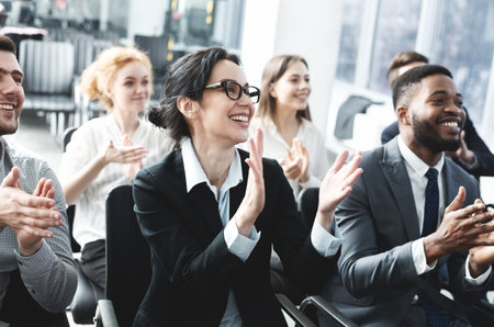 Business lecture. Happy executives applauding to speakerの写真素材
