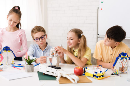 Excited children creating robots together at stem class