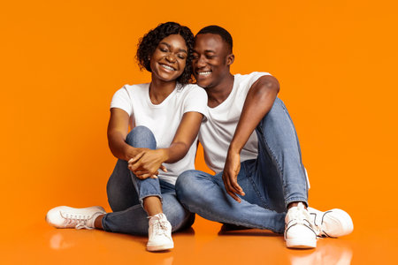 Loving black man and woman having fun, studio shotの写真素材