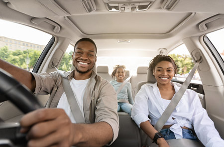 Black Parents And Daughter Riding Car Smiling Enjoying Trip