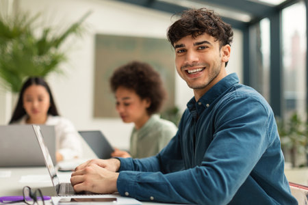 Arab Businessman Using Laptop Sitting At Corporate Meeting In Office