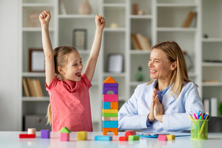 Cute Little Girl And Child Development Specialist Celebrating Therapy Progressの写真素材