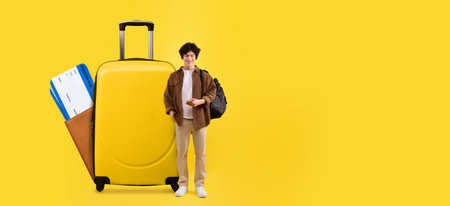 Excited traveler with luggage preparing for summer vacation adventuresの写真素材