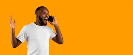 Excited African Guy Talking On Phone Over Yellow Background, Panoramaの写真素材