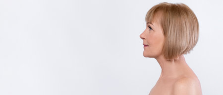 Side view of beautiful senior lady posing half-nakedの写真素材