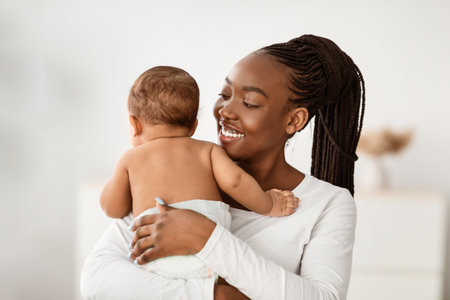Happy African American mom hugging her cute childの写真素材