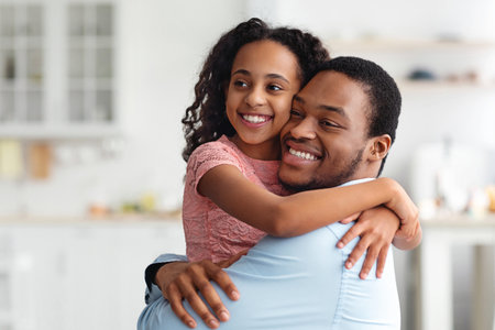 Loving black family father and daughter hugging, copy spaceの写真素材
