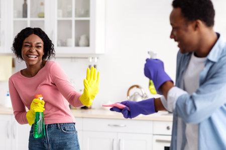 Cute black lovers shooting with cleaning sprays