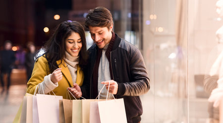 Young loving couple walking looking in shopping bagsの写真素材