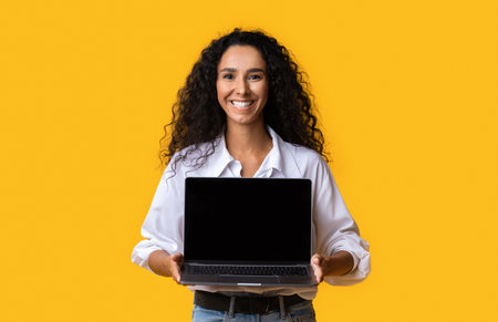 Check This Website. Happy Woman Holding Laptop Computer With Black Blank Screenの写真素材