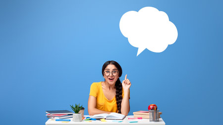 Smiling indian woman pointing up at speech bubbleの写真素材