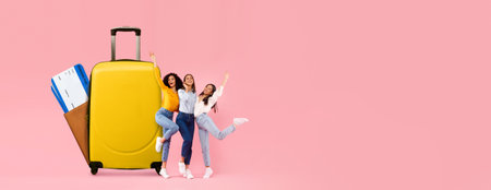 Tourists celebrating vacation plans with luggage and travel essentialsの写真素材