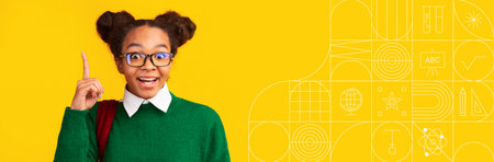 Student studying with enthusiasm against a vibrant yellow backgroundの写真素材