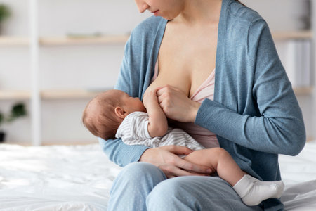 Lactation Concept. Beautiful Smiling Woman Feeding Newborn Baby With Breast At Home