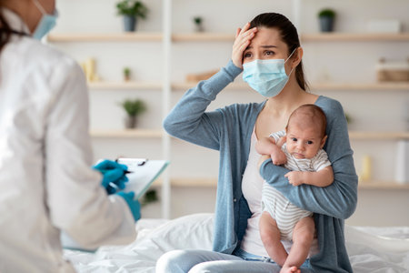 Mother In Protective Mask Holding Newborn Baby, Explaining Illness Symptoms To Doctorの写真素材
