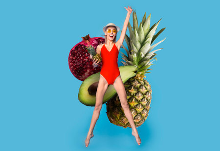 Bright summer joy with fruit and a jumping woman in a vibrant settingの写真素材