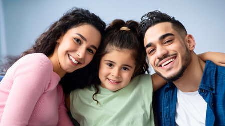 Closeup Portrait Of Happy Arabic Family Of Three With Little Daughterの写真素材
