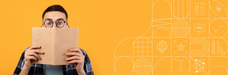 Student studying with a book against a bright painted backgroundの写真素材