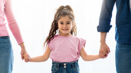 Family Care. Cute Little Preschool Girl Holding Hands With Parents, Closeup Shotの写真素材