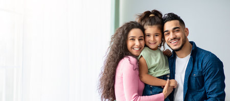 Portrait Of Happy Arabic Parents Posing With Their Little Daughter At Homeの写真素材