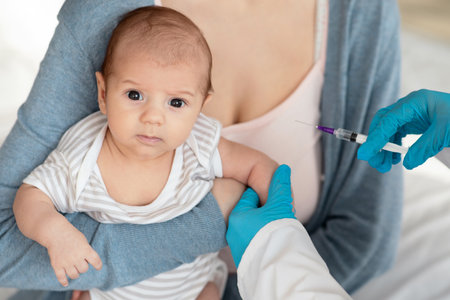 Vaccination. Unrecognizable Pediatrician Doctor Giving Vaccine Shot To Little Baby In Clinicの写真素材