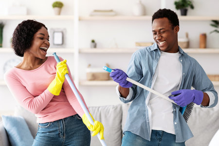 Funny african american family having fun while cleaning apartment, closeupの写真素材