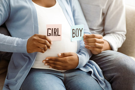 Expecting family holding color cards for baby boy or girlの写真素材