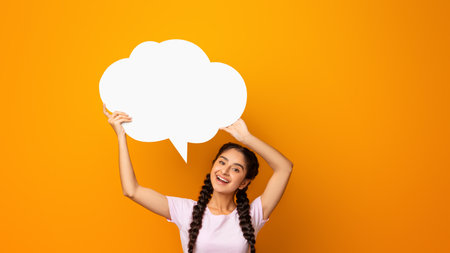 Smiling indian woman hoding speech bubble cloud