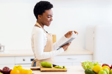 Woman Reading Cooking Book Searching Recipe For Dinner In Kitchenの写真素材