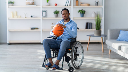Former basketball player in wheelchair holding ball with sadness, cannot play game, feeling...