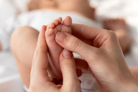 Closeup Shot Of Caring Mother Massaging Her Newborn Babys Footの写真素材