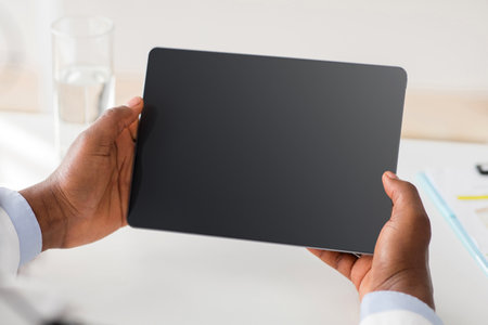 Remote medical consultancy. African american doctor consulting patient via web conference on digital tablet.の写真素材