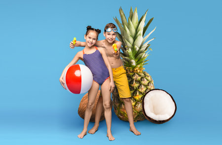 Kids having fun at a summer beach party with fruity decorationsの写真素材