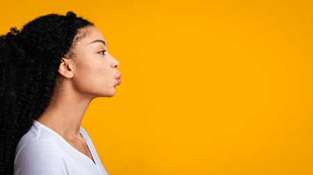Profile Portrait Of Young African American Lady Sending Kiss, Pouting Lipsの写真素材