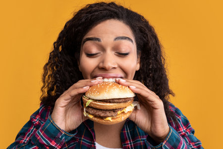Closeup Of Funny Black Lady Eating Burger At Studio