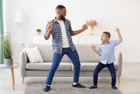 Happy African Father And Son Dancing At Home, Full Lengthの写真素材