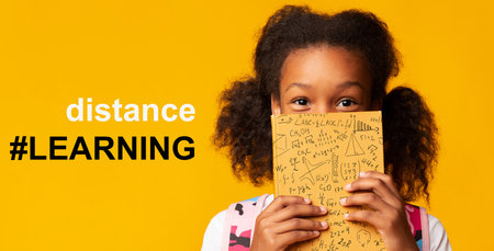 Remote education during COVID-19 epidemic. Cute girl hiding behind book and hashtag DISTANCE LEARNING, collageの写真素材