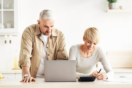 Home bookkeeping, bill payment and planning budget, reading good news, refund or mortgage approvalの写真素材