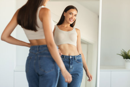 Attractive Woman Posing Smiling Looking At Mirror Posing At Homeの写真素材