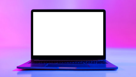 Laptop computer with blank white screen in neon light, mockup for desktop or websiteの写真素材