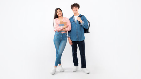 Cheerful Young Students Duo Standing With Backpacks Over White Background