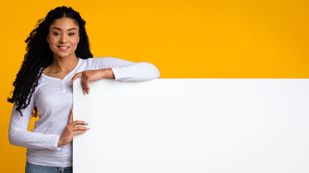 Place For Your Ad. Smiling Black Lady Standing Next To White Boardの写真素材