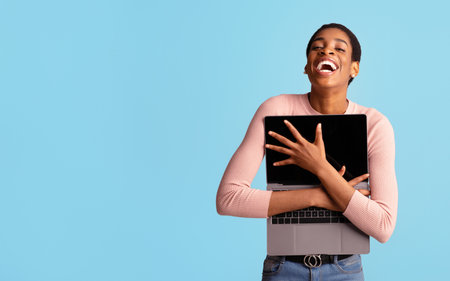 Online Shopping Lover. Cheerful Black Lady Embracing Opened Laptop And Laughing