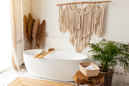 Cozy modern minimalistic bathroom interior with big white bathtube indoorsの写真素材