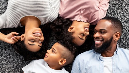 Portrait of black family lying on floor togetherの写真素材
