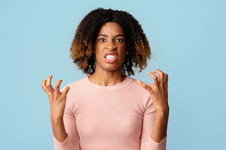 Portrait Of Angry African American Woman Looking AT Camera With Rage