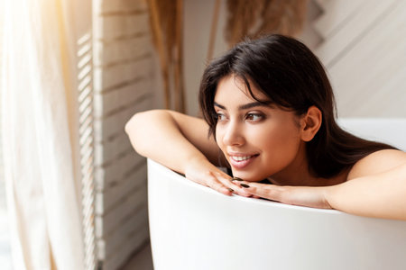Relaxed Young Lady Taking Bath Lying In Bathtub In Bathroomの写真素材