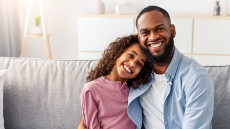 Portrait of black father and daughter huggingの写真素材